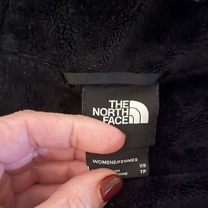 Black windblocking and water resistent with faux fur inside lining and hood